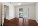 Bedroom with hardwood floors, ceiling fan, and sliding glass doors to the pool area at 1038 Greenturf Rd, Spring Hill, FL 34608