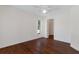 Spacious bedroom with hardwood floors, closet, and window at 1038 Greenturf Rd, Spring Hill, FL 34608
