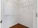 Walk-in closet with white wire shelving and hardwood floors at 1038 Greenturf Rd, Spring Hill, FL 34608
