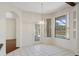 Dining area with tile floors, pendant lighting, and views of the outdoor pool area at 1038 Greenturf Rd, Spring Hill, FL 34608