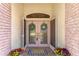Close up of front door, featuring wreath decorations, hardware and welcome mat at 1038 Greenturf Rd, Spring Hill, FL 34608
