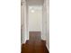 Hallway with hardwood floors leading to a bedroom with a ceiling fan at 1038 Greenturf Rd, Spring Hill, FL 34608