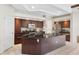 Spacious kitchen features dark wood cabinetry, granite countertops, stainless steel appliances, and a large center island at 1038 Greenturf Rd, Spring Hill, FL 34608