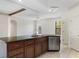 Open kitchen with an island, stainless steel appliances, and views of the living area and backyard at 1038 Greenturf Rd, Spring Hill, FL 34608