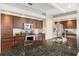 Close-up view of the kitchen's dark granite countertops, stainless steel appliances, and plentiful cabinetry at 1038 Greenturf Rd, Spring Hill, FL 34608