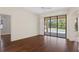 Spacious living room with hardwood floors and sliding glass doors that open to the pool area at 1038 Greenturf Rd, Spring Hill, FL 34608