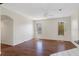 Bright living room featuring hardwood floors, ceiling fan, and natural light from two windows at 1038 Greenturf Rd, Spring Hill, FL 34608