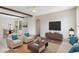 Staged living room with modern furniture, hardwood floors, and bright natural light at 1038 Greenturf Rd, Spring Hill, FL 34608