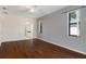 Spacious main bedroom with hardwood floors leading to a bathroom at 1038 Greenturf Rd, Spring Hill, FL 34608