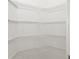 Walk-in pantry with ample shelving for organized storage at 1038 Greenturf Rd, Spring Hill, FL 34608
