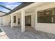 Covered patio offers brick pavers, ceiling fan, and serene outdoor living space with lots of windows at 1038 Greenturf Rd, Spring Hill, FL 34608