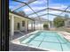 Screened-in pool area with a covered patio and easy access from inside at 1038 Greenturf Rd, Spring Hill, FL 34608