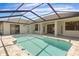 Backyard pool with screened-in lanai enclosure and outdoor space perfect for outdoor entertaining at 1038 Greenturf Rd, Spring Hill, FL 34608