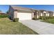Charming home featuring a two-car garage, brick accents, and well-manicured landscaping at 1051 Almondwood Dr, Trinity, FL 34655