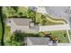 Aerial view showcases the property's expansive landscaping, driveway, and proximity to neighboring homes at 11428 Hidden Cove Ct, Trinity, FL 34655