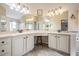 Bathroom featuring double sinks, vanity area and neutral tile flooring at 11428 Hidden Cove Ct, Trinity, FL 34655