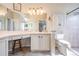 Bright bathroom with vanity area, stool and tiled shower at 11428 Hidden Cove Ct, Trinity, FL 34655
