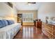 Bright bedroom with hardwood floors, shuttered windows and ample natural light at 11428 Hidden Cove Ct, Trinity, FL 34655