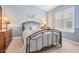Cozy bedroom with blue walls, carpet and bright window at 11428 Hidden Cove Ct, Trinity, FL 34655