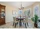 Cozy dining area with ample natural light, stylish furnishings and tile floors at 11428 Hidden Cove Ct, Trinity, FL 34655