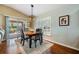 Light-filled dining area featuring stylish chandelier and sliding doors to the patio at 11428 Hidden Cove Ct, Trinity, FL 34655