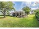 Well-manicured lawn and landscaping highlighting the home's exterior at 11428 Hidden Cove Ct, Trinity, FL 34655
