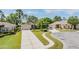 Exterior shot showcasing landscaping, and driveway at 11428 Hidden Cove Ct, Trinity, FL 34655