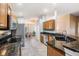 Modern kitchen featuring granite countertops, stainless steel appliances, and tile flooring at 11428 Hidden Cove Ct, Trinity, FL 34655