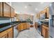 Contemporary kitchen with stainless steel appliances, granite counters and sleek cabinetry at 11428 Hidden Cove Ct, Trinity, FL 34655