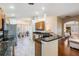 Open-concept kitchen with stainless steel appliances and views of the dining and living areas at 11428 Hidden Cove Ct, Trinity, FL 34655