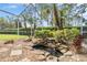 Lush landscaping and water feature in lanai with a screened enclosure at 11428 Hidden Cove Ct, Trinity, FL 34655