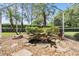Lush landscaping and water feature in lanai with a screened enclosure at 11428 Hidden Cove Ct, Trinity, FL 34655