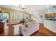 Inviting living room featuring hardwood floors, comfortable seating, and plenty of natural light at 11428 Hidden Cove Ct, Trinity, FL 34655