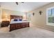 Bright main bedroom with plush carpet and abundant natural light from shuttered windows at 11428 Hidden Cove Ct, Trinity, FL 34655