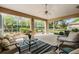 Relaxing screened-in patio with comfortable seating and views of the serene backyard garden at 11428 Hidden Cove Ct, Trinity, FL 34655