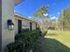 Side view of a home featuring shuttered windows and a well-maintained landscape at 12342 Quigley Ave, Weeki Wachee, FL 34614