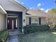 Home's inviting front entrance featuring a maroon door with welcome sign at 12342 Quigley Ave, Weeki Wachee, FL 34614
