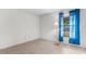 The room boasts a window with blue curtains, neutral floors and painted walls at 12467 Montego St, Spring Hill, FL 34609