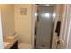 Cozy bathroom featuring a shower and decorative beach artwork at 12820 Wedgewood Way # D, Hudson, FL 34667