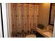 Cozy bathroom with palm tree shower curtain and vanity at 12820 Wedgewood Way # D, Hudson, FL 34667