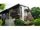Exterior view of a two-story townhouse featuring a private balcony and well-maintained landscaping at 12820 Wedgewood Way # D, Hudson, FL 34667