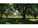 Lush community green space featuring mature shade trees and manicured lawn at 12820 Wedgewood Way # D, Hudson, FL 34667