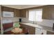 A well-lit kitchen features wood cabinets, white appliances, and a charming breakfast nook at 12820 Wedgewood Way # D, Hudson, FL 34667