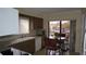 Kitchen features a sink, dishwasher, and breakfast table with sliding doors to balcony at 12820 Wedgewood Way # D, Hudson, FL 34667