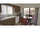 Cozy kitchen with wood cabinets, a breakfast table, and a view of the neighborhood at 12820 Wedgewood Way # D, Hudson, FL 34667