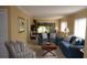 Relax in this living room featuring large windows, neutral carpeting, and comfortable furnishings at 12820 Wedgewood Way # D, Hudson, FL 34667
