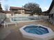 Inviting community pool and hot tub area with ample seating and well-maintained landscaping at 12820 Wedgewood Way # D, Hudson, FL 34667