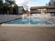 Community swimming pool surrounded by lounge chairs and landscaping at 12820 Wedgewood Way # D, Hudson, FL 34667