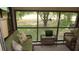 Relaxing sunroom with comfortable seating and a view of the well-maintained outdoor space at 12820 Wedgewood Way # D, Hudson, FL 34667