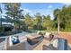 This backyard features a firepit with seating, a putting green, and mature landscaping at 1312 Lake Polo Dr, Odessa, FL 33556